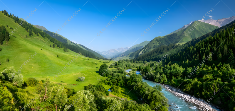 Breathtaking view of serene river flowing through lush green valley in mountainous landscape during clear sunny day